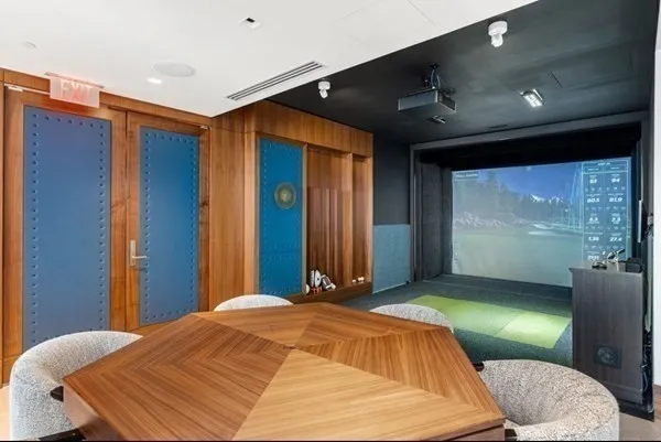 a bedroom with a bed and a large mirror