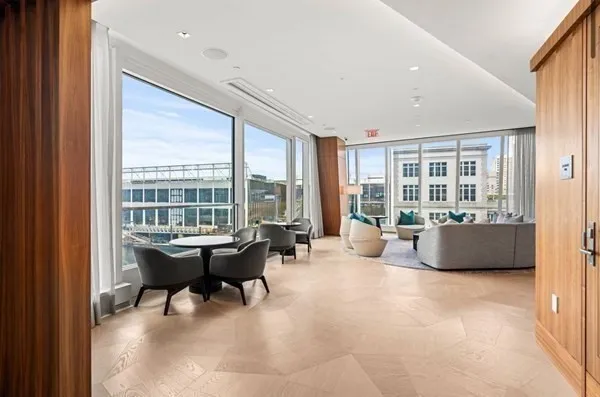 a lobby with furniture and large windows
