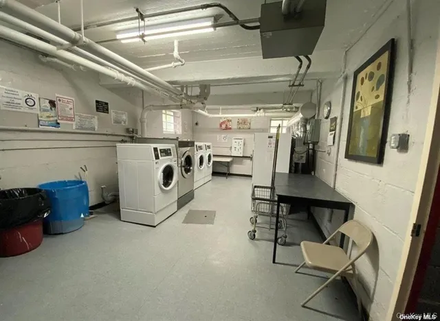 a utility room with multiple dryer and washer