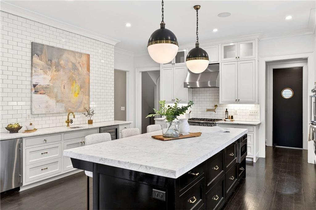 3773 Randall Road Southeast Atlanta, GA 30339 - Photo 16 of 64 a kitchen with a stove a sink and a wooden floor
