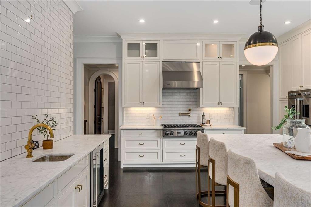 3773 Randall Road Southeast Atlanta, GA 30339 - Photo 19 of 64 a kitchen with stainless steel appliances a sink a stove a refrigerator cabinets and living room view