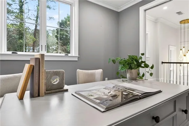 a front view of a house with yard and green space