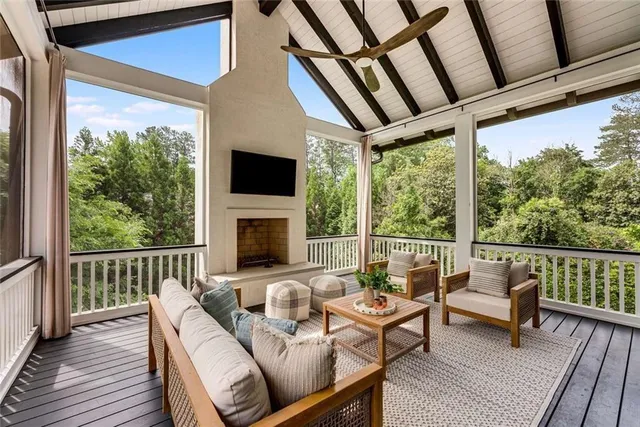 a dining hall with stainless steel appliances kitchen island granite countertop a stove a sink a dining table and chairs with wooden floor