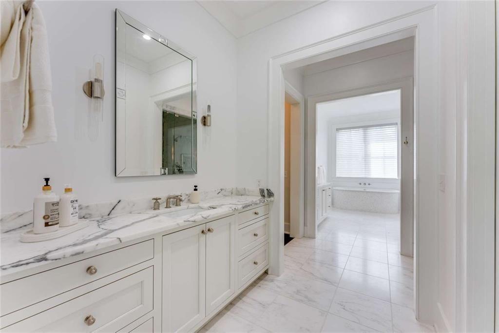 3773 Randall Road Southeast Atlanta, GA 30339 - Photo 29 of 64 a spacious bathroom with a granite countertop sink a mirror and a