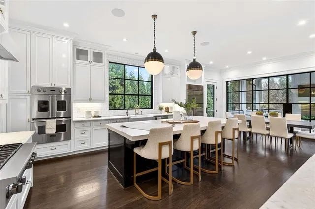 a living room with furniture fireplace and a large window