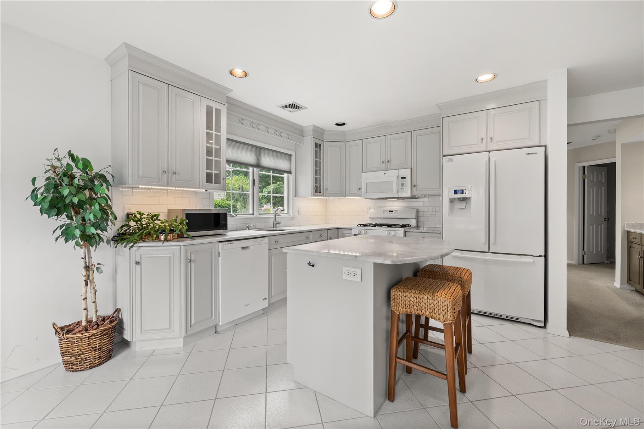 34 Cedar Ridge Lane Bay Shore, NY 11706 - Photo 4 of 27 a kitchen with white cabinets and white appliances
