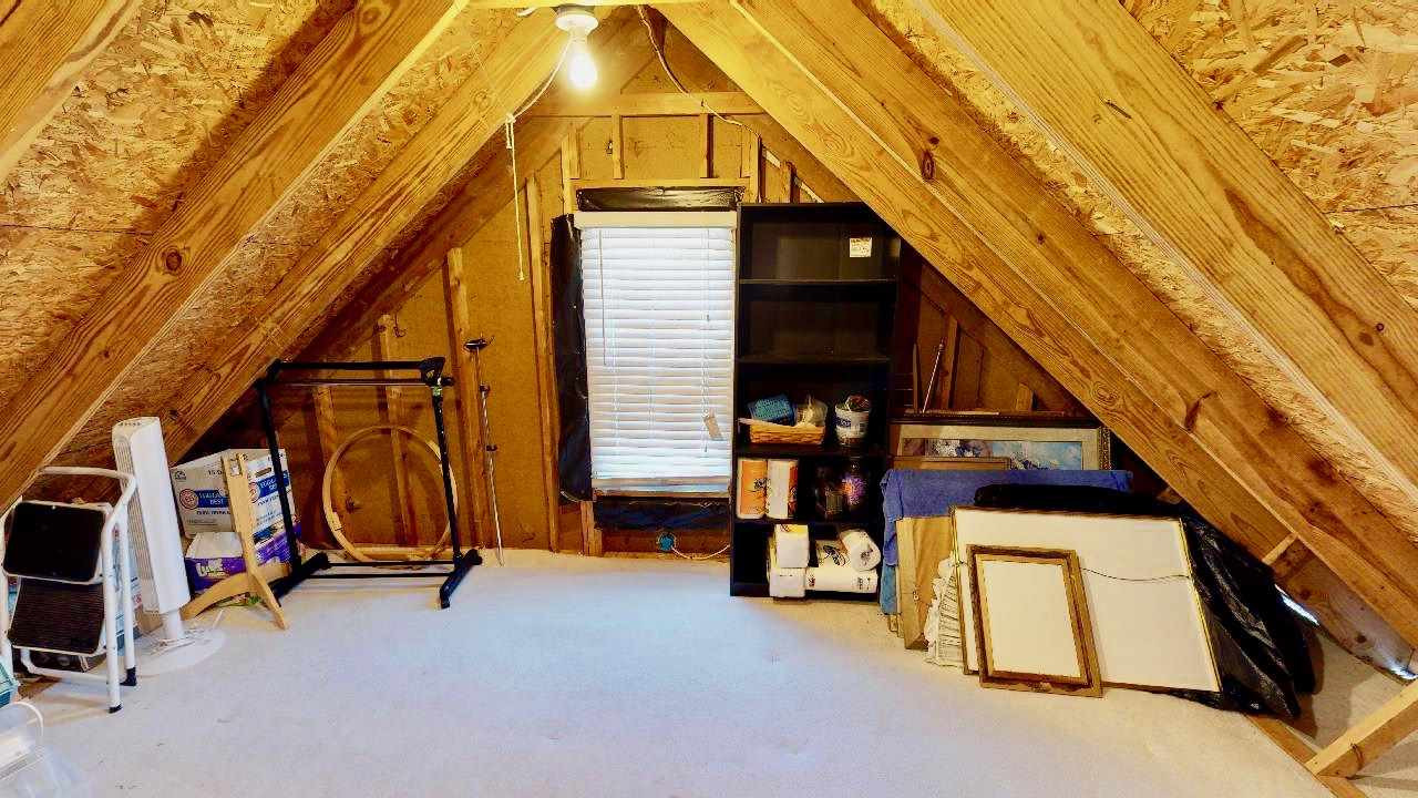 7504 Boscobel Way Raleigh, NC 27615 - Photo 22 of 25 Walk-in attic upstairs provides tons of storage! This house also has lots of closets and overhead storage in the garage! Attic