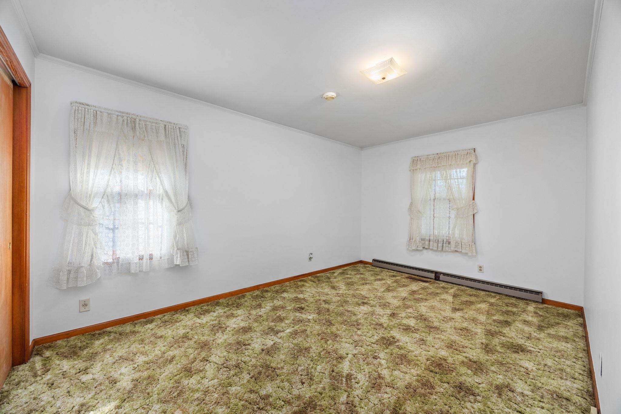 213 Forrest School Road Corinth, MS 38834 - Photo 16 of 40 Carpeted empty room with crown molding and a baseboard heating unit