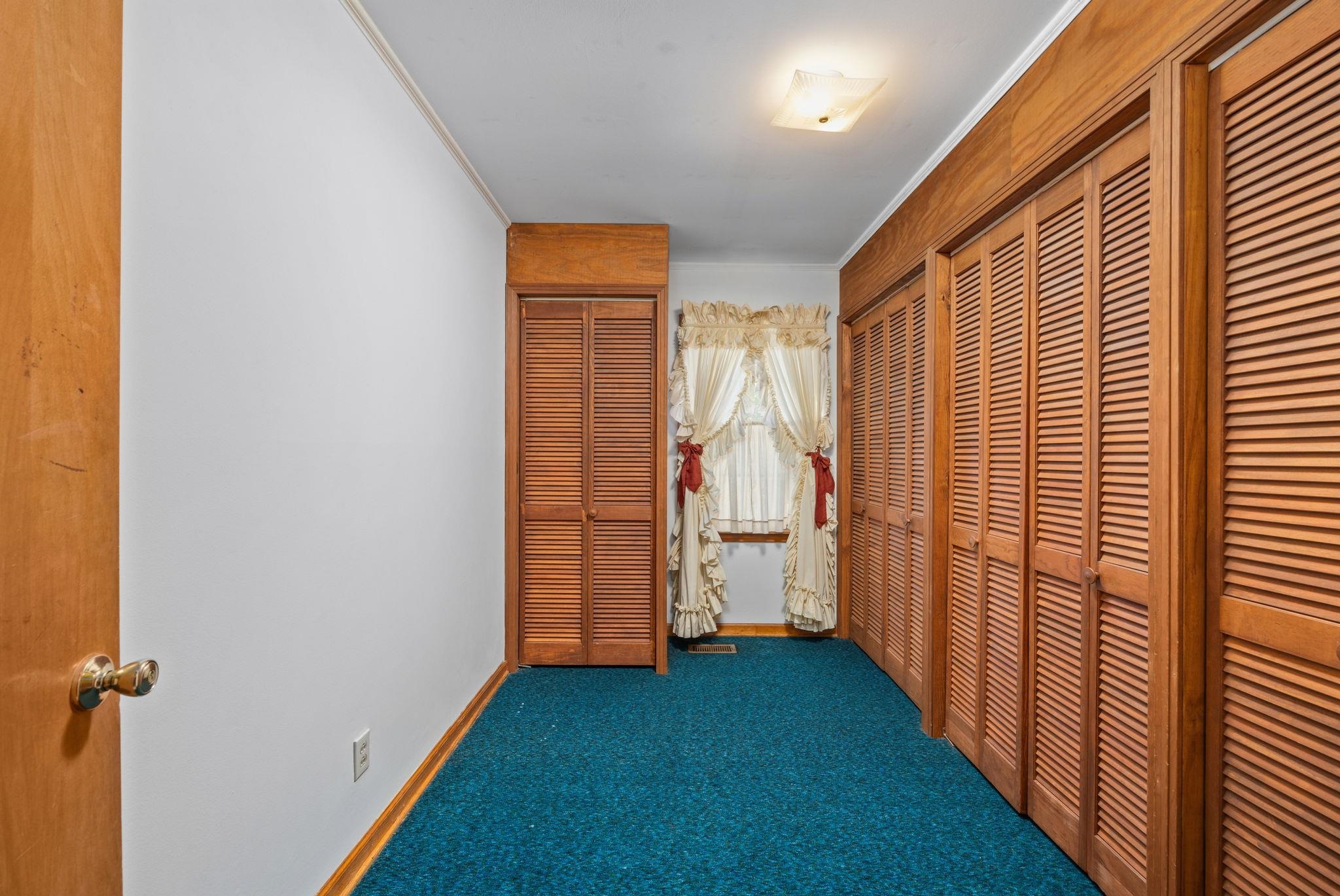213 Forrest School Road Corinth, MS 38834 - Photo 18 of 40 Hallway with dark carpet and crown molding