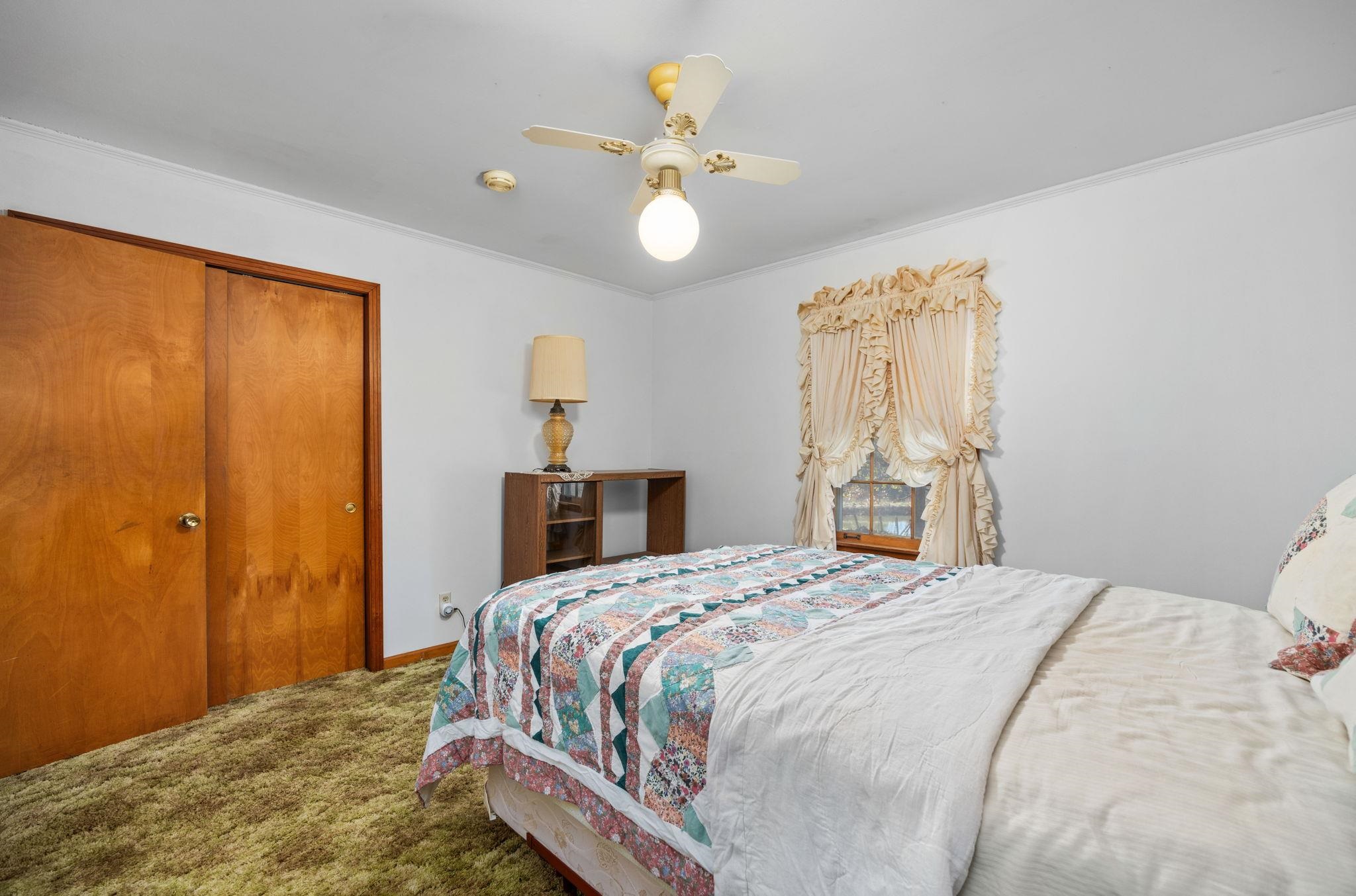 213 Forrest School Road Corinth, MS 38834 - Photo 20 of 40 Bedroom featuring carpet flooring, a closet, crown molding, and ceiling fan