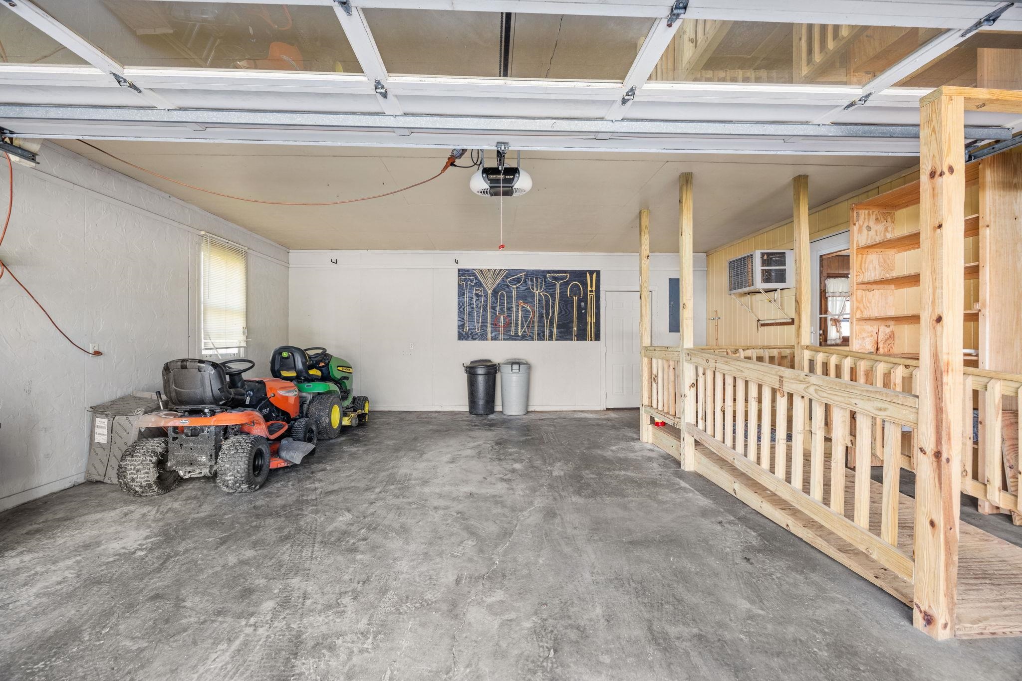 213 Forrest School Road Corinth, MS 38834 - Photo 24 of 40 Garage with a garage door opener and an AC wall unit