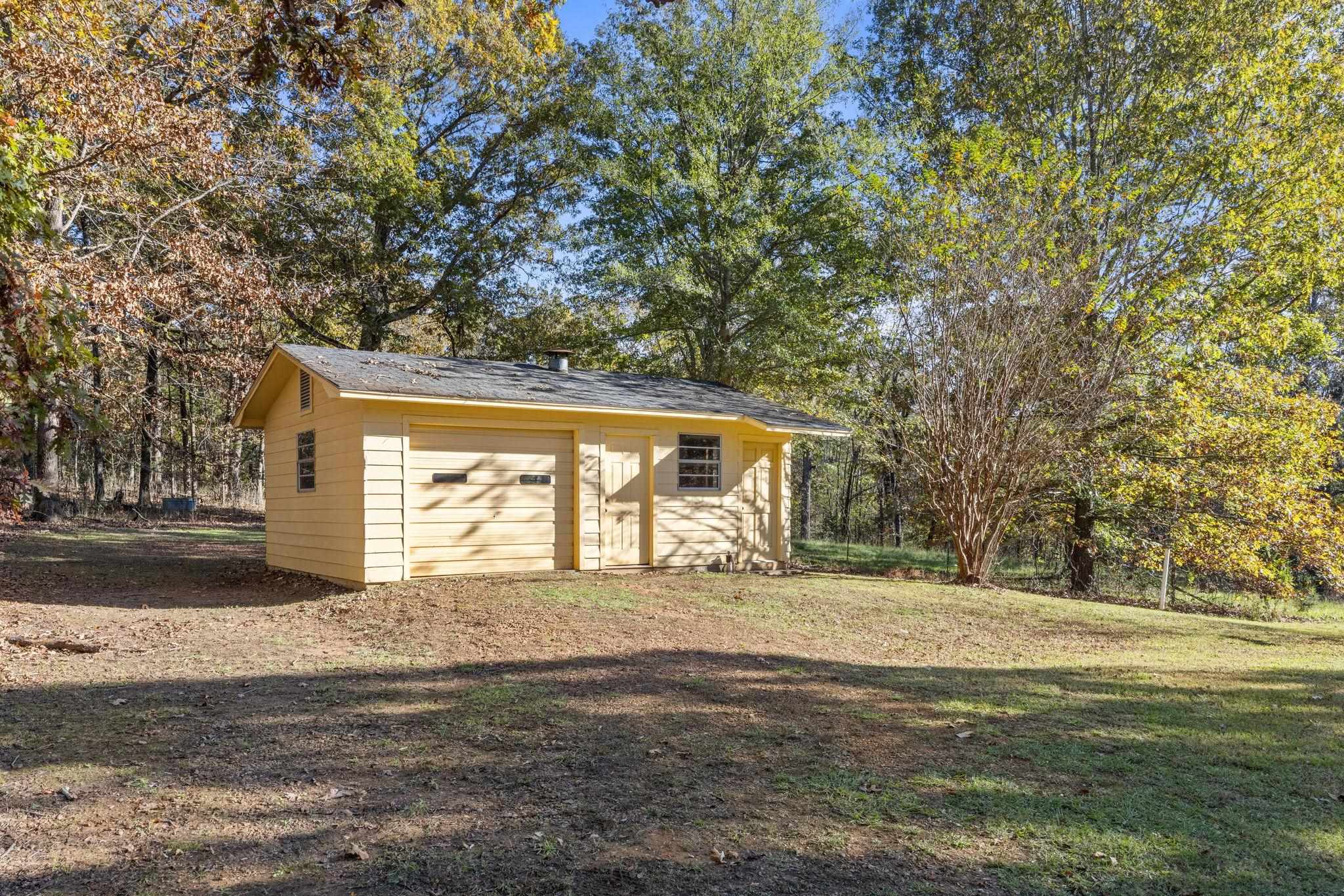 213 Forrest School Road Corinth, MS 38834 - Photo 30 of 40 View of outbuilding featuring a lawn and a garage