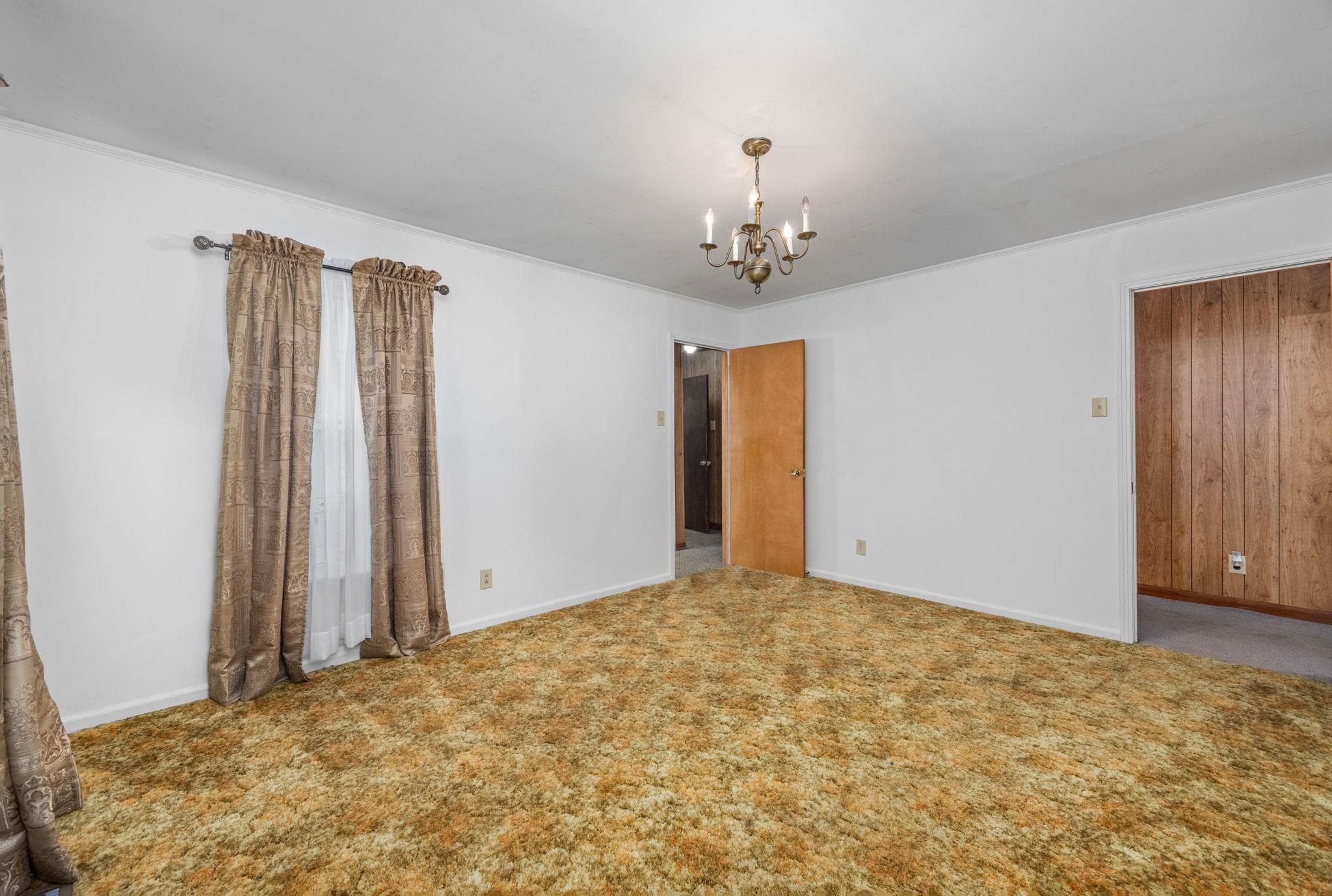 213 Forrest School Road Corinth, MS 38834 - Photo 5 of 40 Carpeted empty room featuring a chandelier