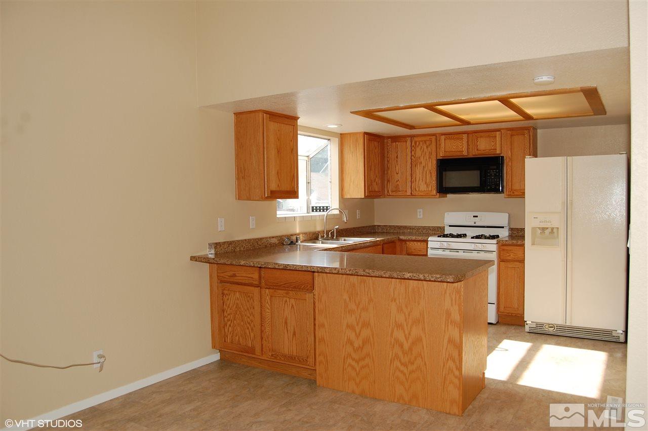 2415 Durango Court Reno, NV 89503 - Photo 5 of 25 a kitchen with stainless steel appliances a sink and a refrigerator