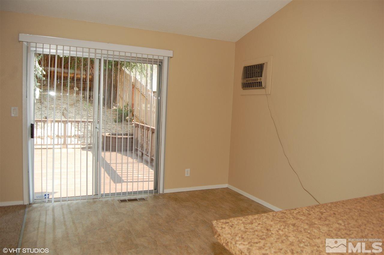 2415 Durango Court Reno, NV 89503 - Photo 9 of 25 a view of an empty room with wooden floor and a window