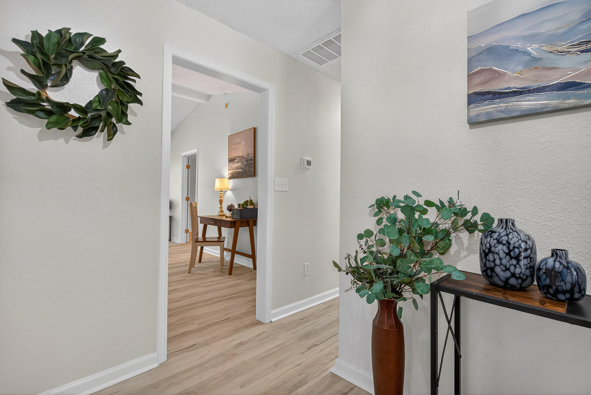 4297 Edge Perry Road Crestview, FL 32539 - Photo 11 of 70 a view of a hallway with wooden floor and a vase