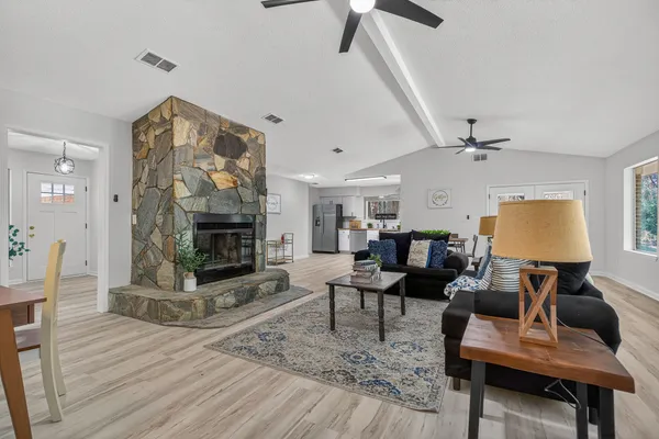 a living room with furniture and a fireplace