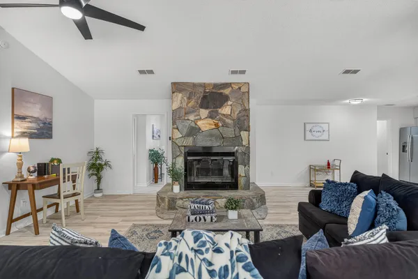 a living room with furniture and a wooden floor