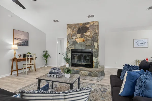 a living room with furniture and a wooden floor