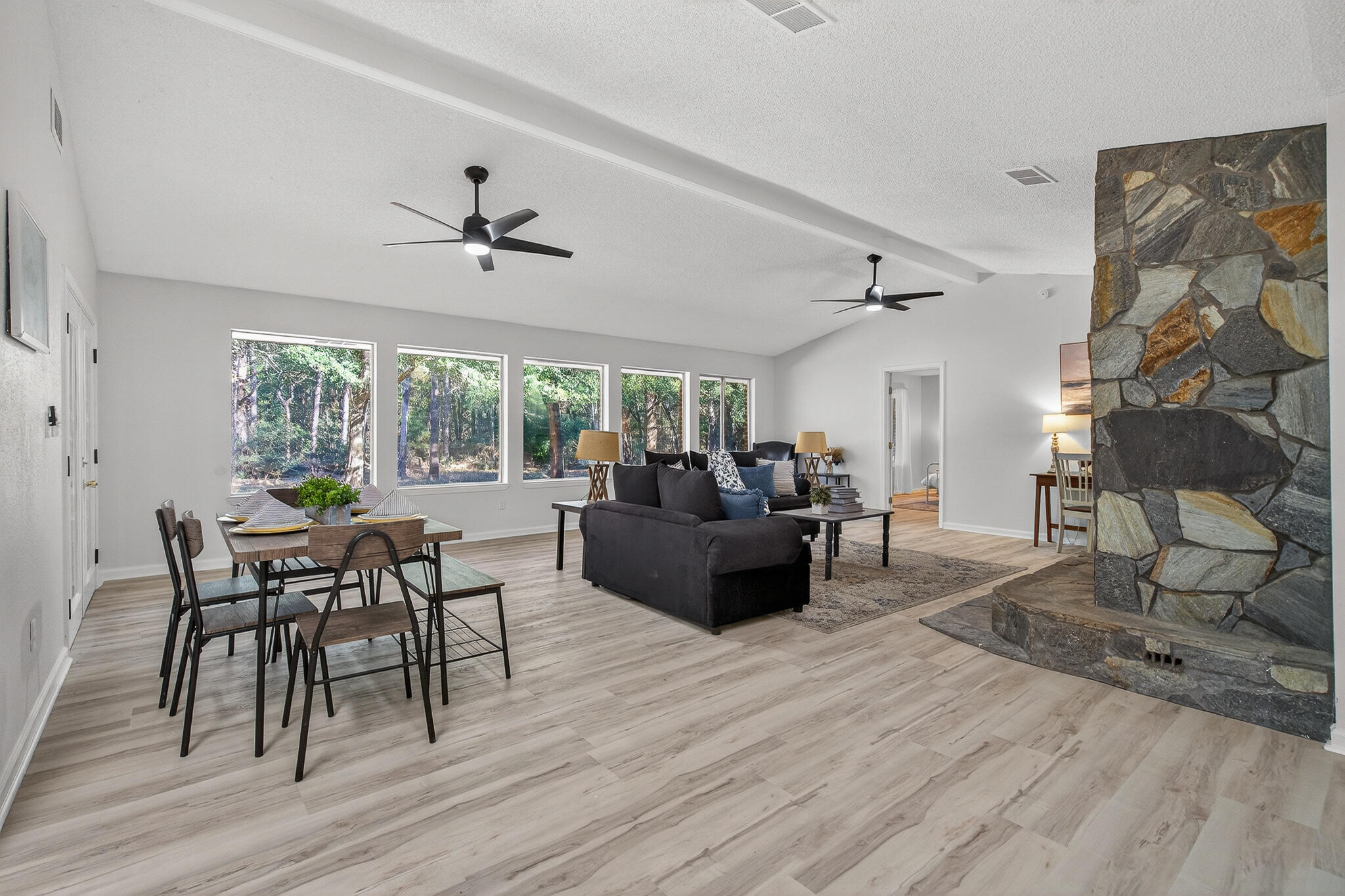 4297 Edge Perry Road Crestview, FL 32539 - Photo 24 of 70 a living room with furniture dining table and a floor to ceiling window