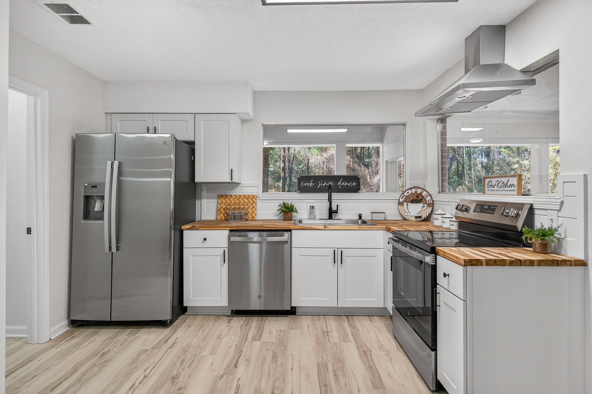 4297 Edge Perry Road Crestview, FL 32539 - Photo 32 of 70 a kitchen with stainless steel appliances a refrigerator stove and sink