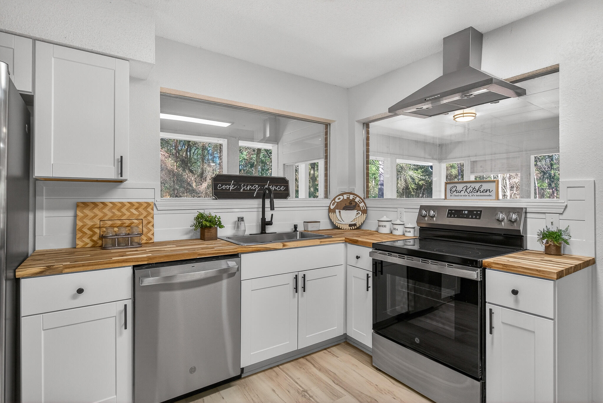4297 Edge Perry Road Crestview, FL 32539 - Photo 33 of 70 a kitchen with white cabinets stainless steel appliances and sink