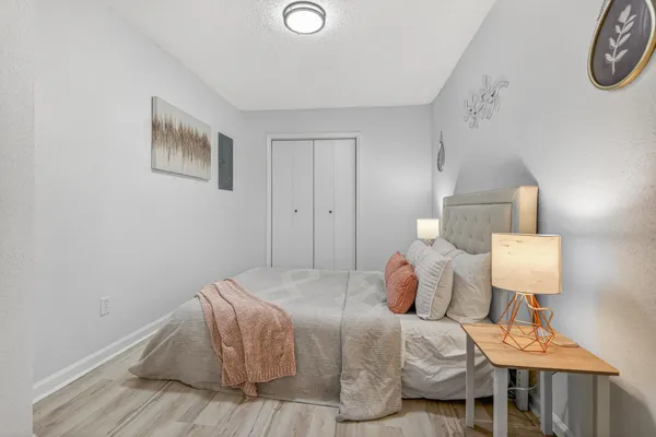 a bedroom with a bed and wooden floor