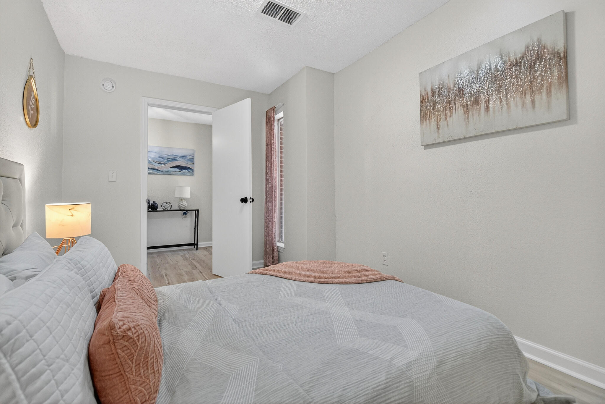 4297 Edge Perry Road Crestview, FL 32539 - Photo 38 of 70 a bedroom with a bed and a lamp on dresser