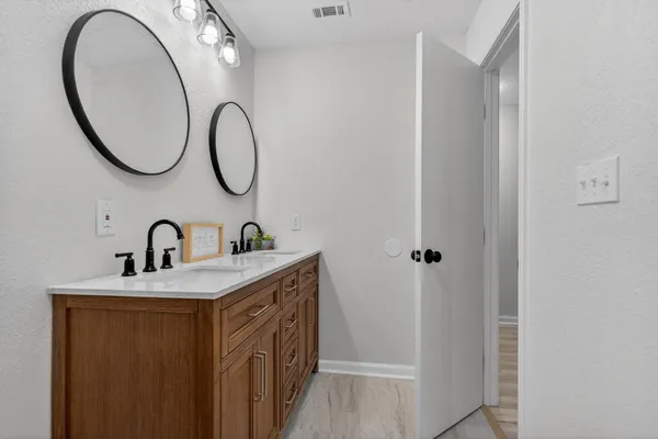 a bathroom with a toilet a sink and a window