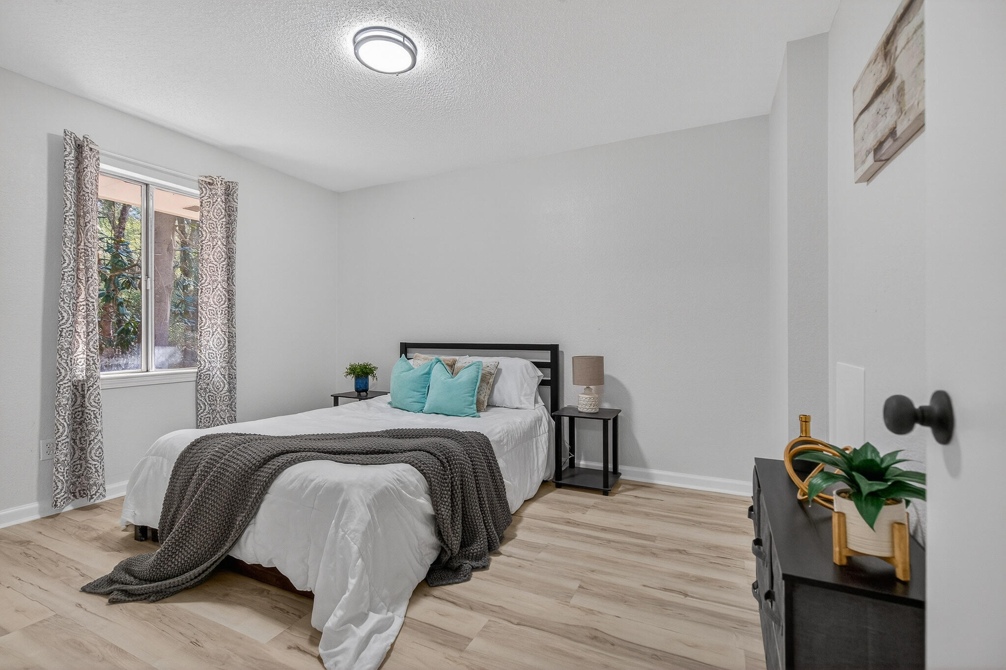 4297 Edge Perry Road Crestview, FL 32539 - Photo 43 of 70 a bedroom with a bed and a potted plant