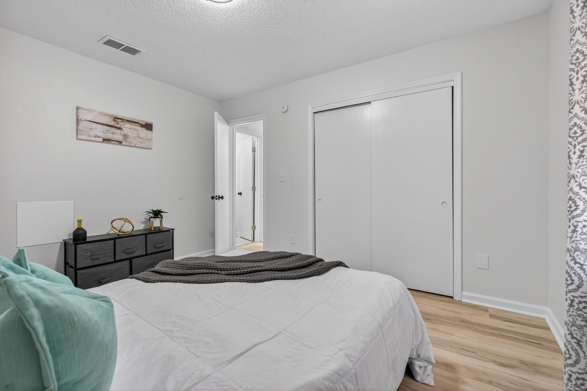 4297 Edge Perry Road Crestview, FL 32539 - Photo 47 of 70 a bedroom with a bed and wooden floor