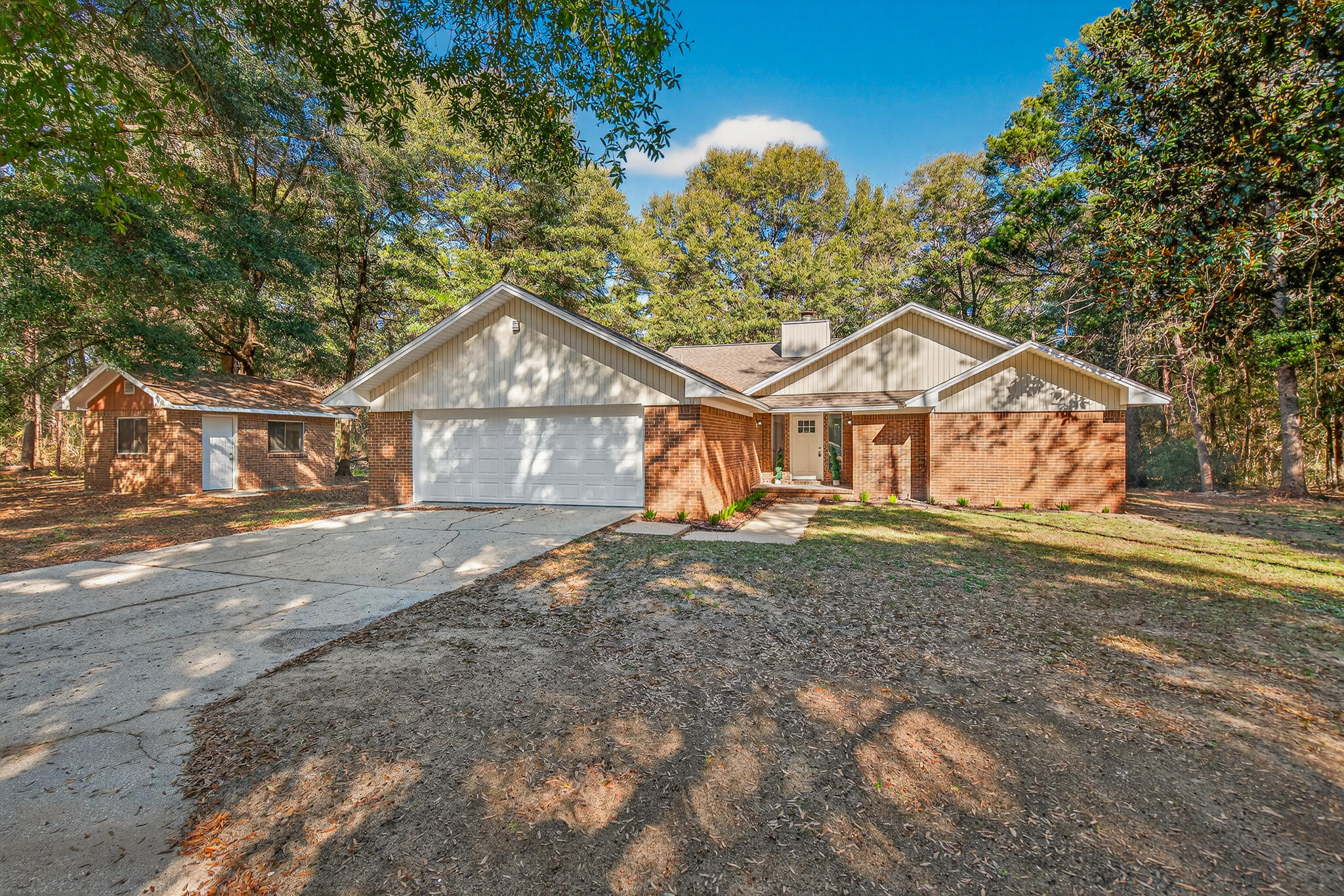 4297 Edge Perry Road Crestview, FL 32539 - Photo 5 of 70 a front view of a house with a yard and garage