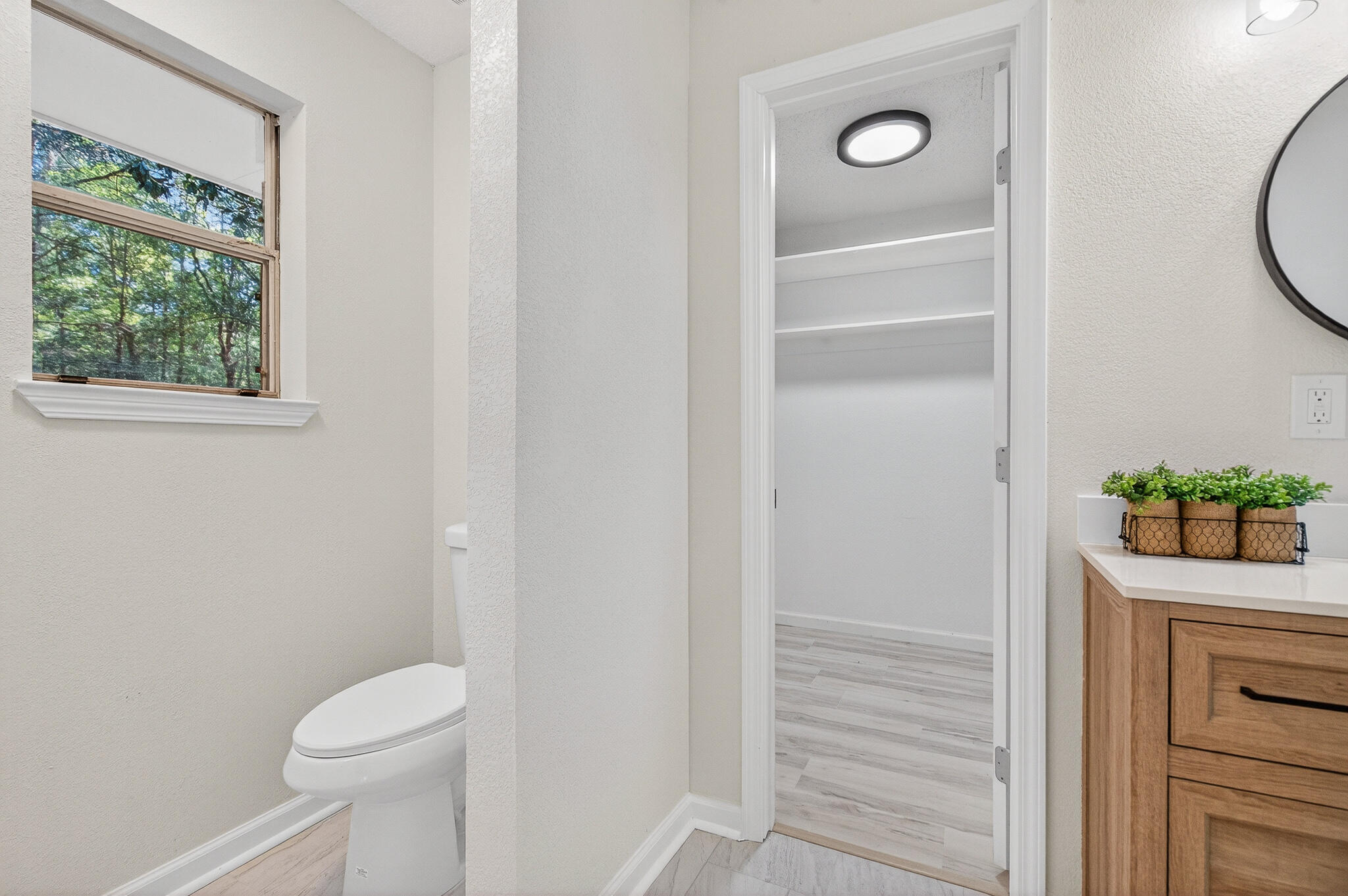 4297 Edge Perry Road Crestview, FL 32539 - Photo 56 of 70 a bathroom with a toilet a sink and a window