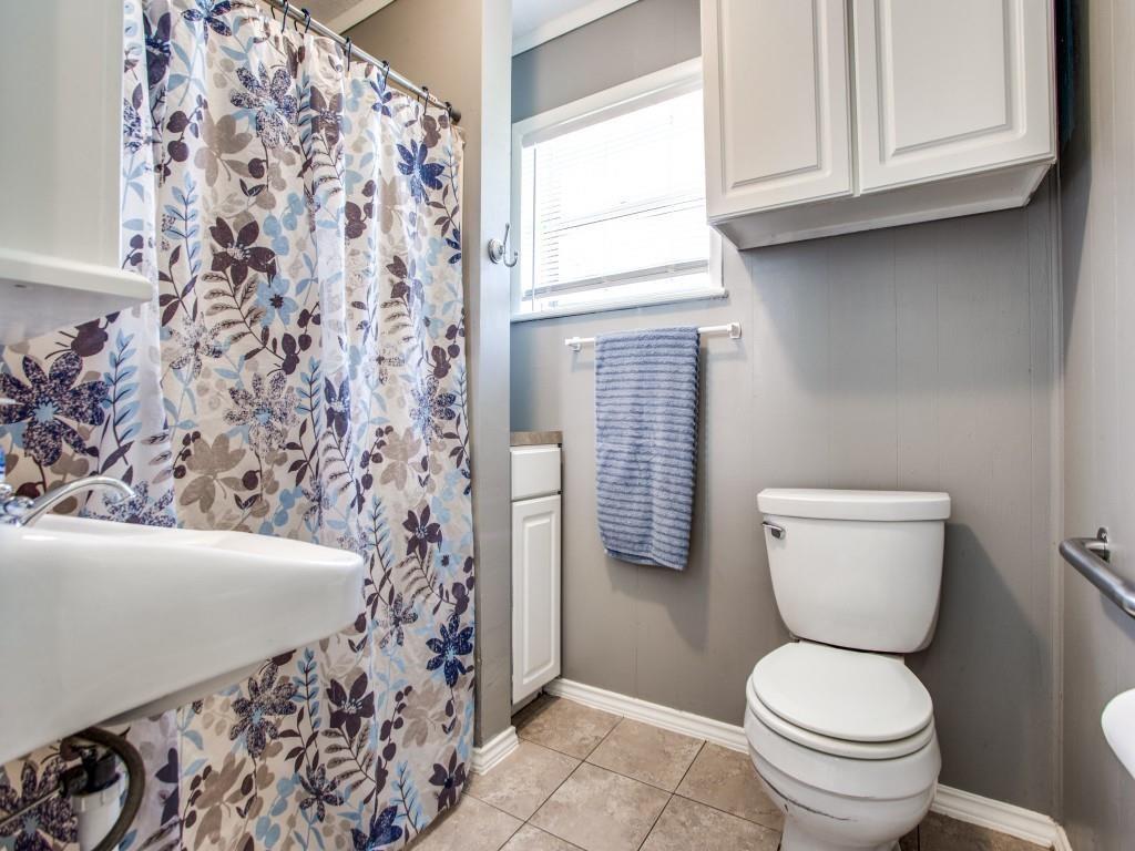 500 North 5th Street Gunter, TX 75058 - Photo 5 of 11 a bathroom with a toilet and a shower curtain