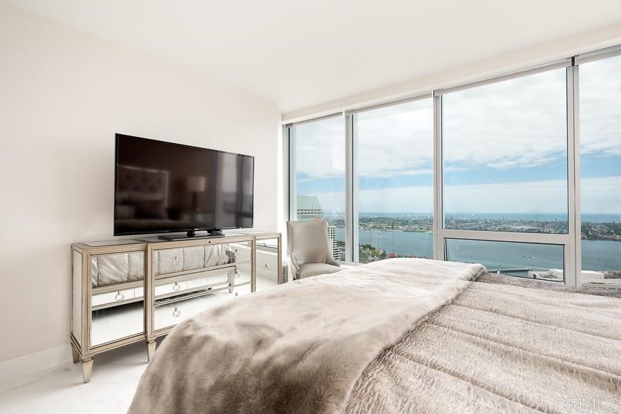 888 West E Street San Diego, CA 92101 - Photo 12 of 30 a bedroom with a bed and a flat screen tv