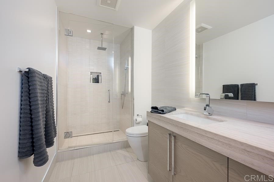 888 West E Street San Diego, CA 92101 - Photo 26 of 30 a bathroom with a sink a toilet and shower