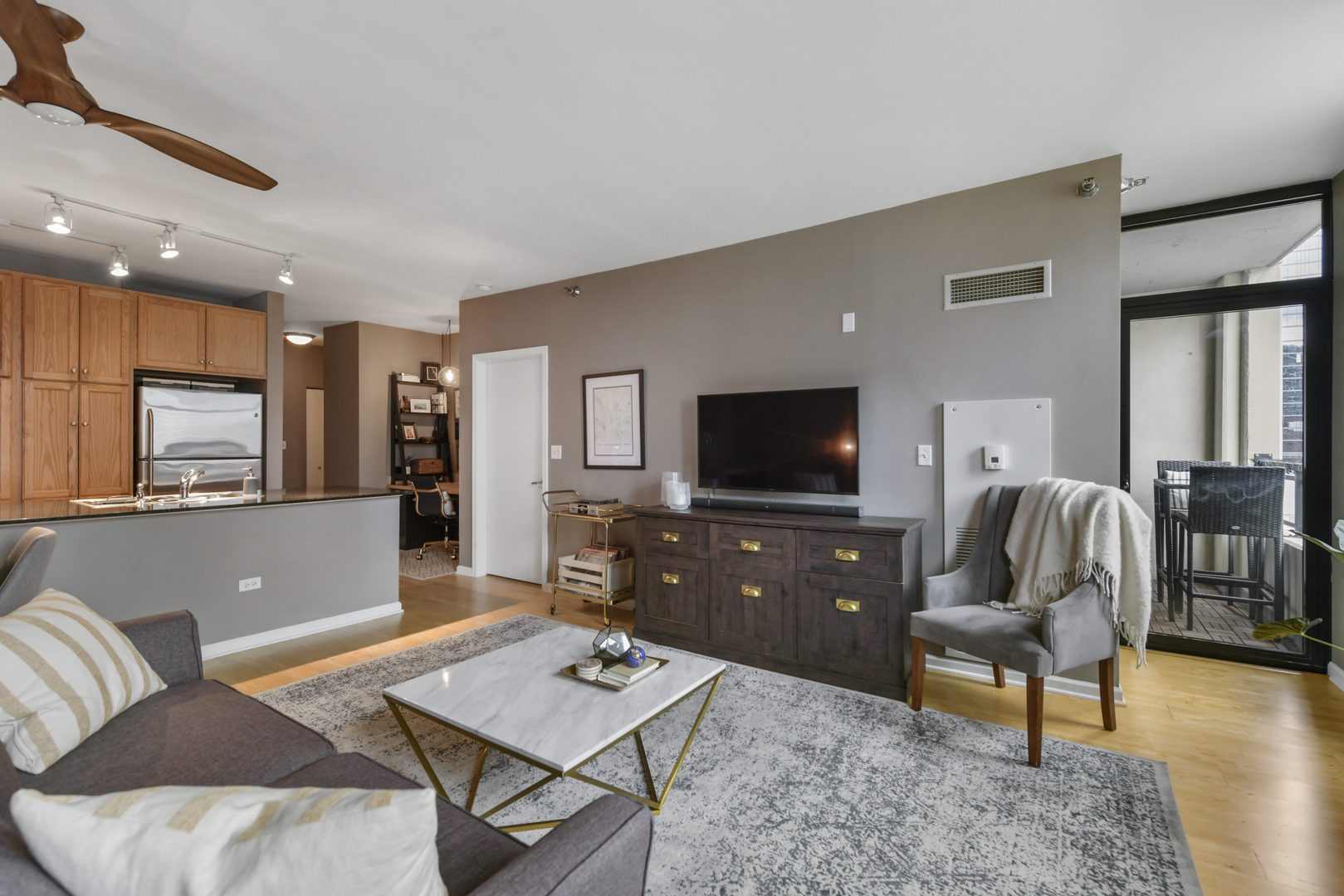 1255 South State Street, Unit 807 Chicago, IL 60605 - Photo 2 of 13 a living room with furniture and a flat screen tv