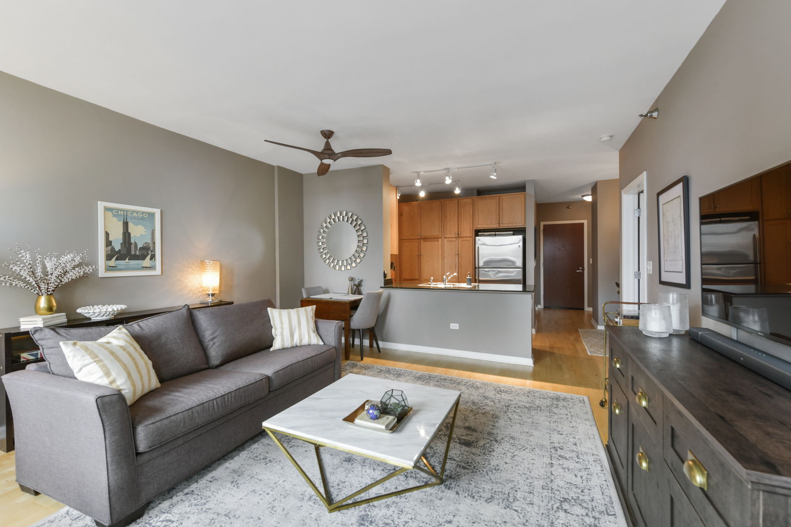 1255 South State Street, Unit 807 Chicago, IL 60605 - Photo 4 of 13 a living room with furniture and a flat screen tv