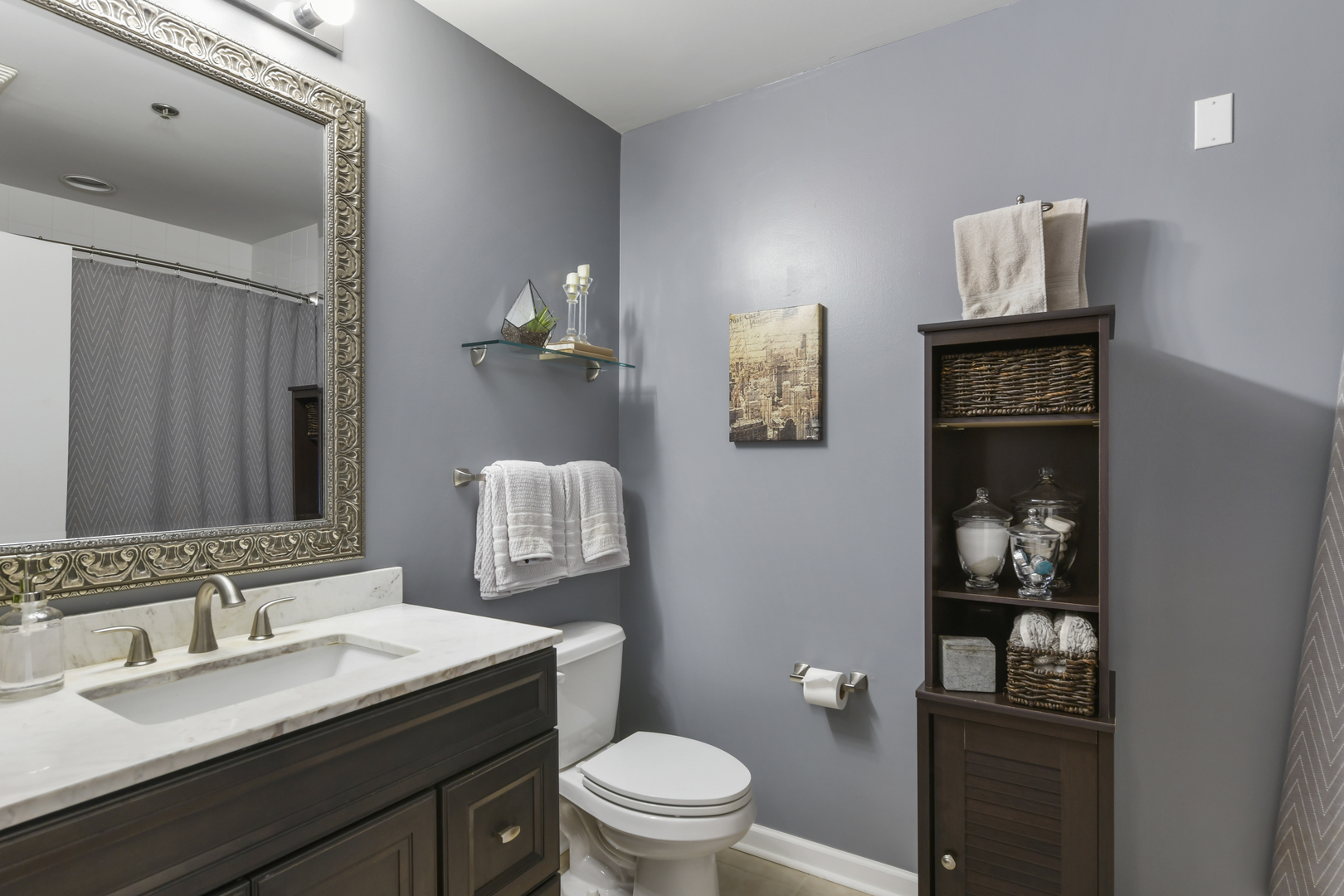 1255 South State Street, Unit 807 Chicago, IL 60605 - Photo 10 of 13 a bathroom with a granite countertop sink a toilet and mirror