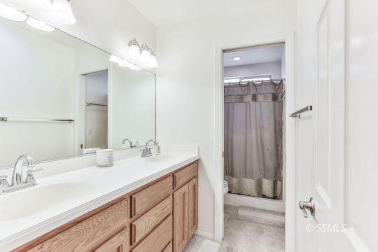 1214 North Guam Street Ridgecrest, CA 93555 - Photo 32 of 48 a bathroom with a sink vanity and a mirror