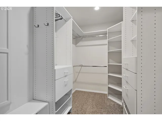 a view of walk in closet with empty racks