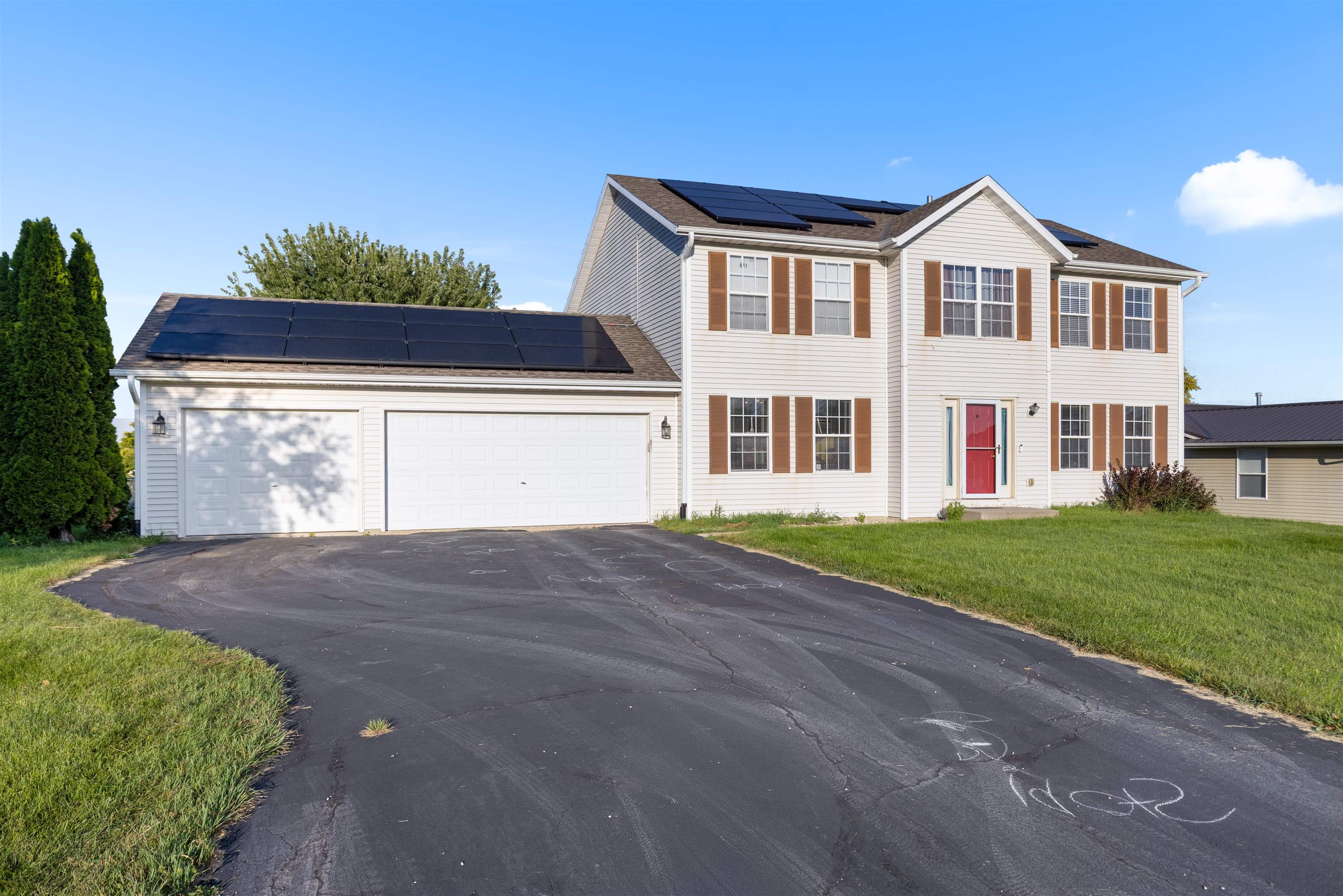 1405 Sentry Drive Durand, IL 61024 - Photo 25 of 25 a front view of a house with a yard and garage