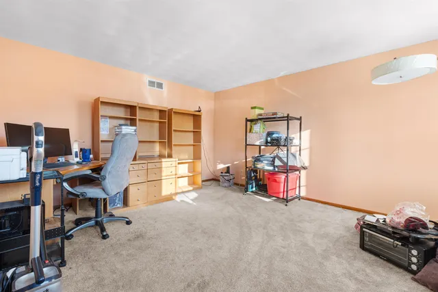 a bedroom with furniture and a large window