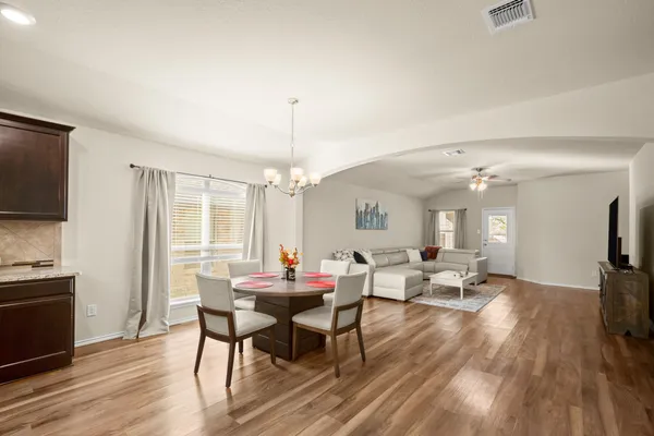 a view of a dining room with furniture window and wooden floor