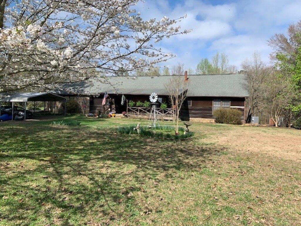 3260 East Fairview Road Southwest Stockbridge, GA 30281 - Photo 1 of 1 a front view of a building with a garden