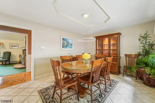 a view of a dining room with furniture and a potted plant