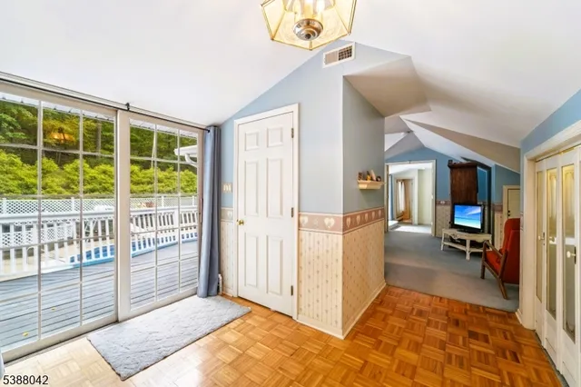 a view of a hallway to a livingroom with furniture