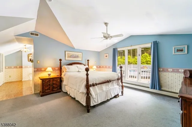 a spacious bedroom with a bed and a lamp