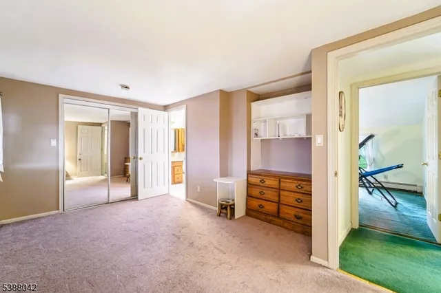 a view of an empty room and a kitchen