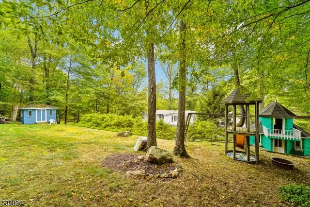 a view of an house with backyard space and balcony